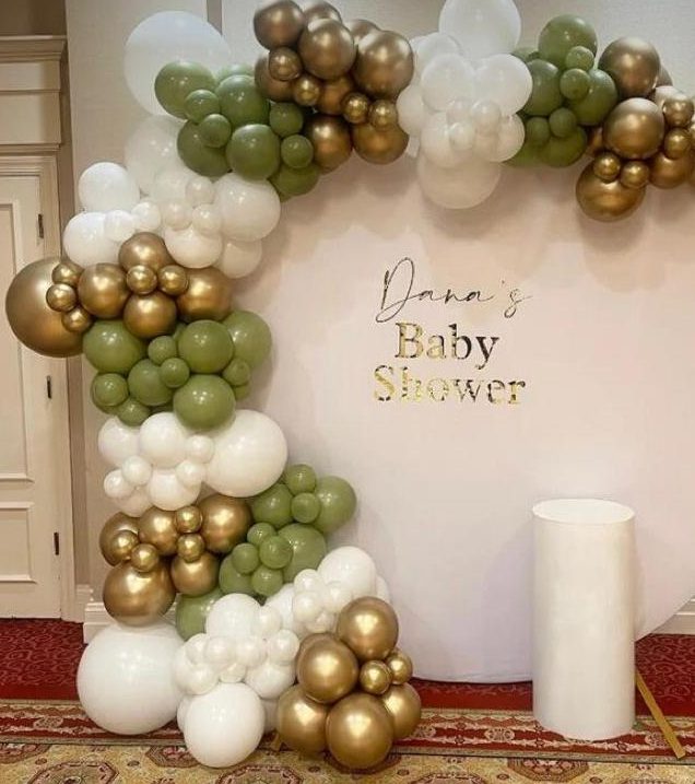 Olive green, white and gold balloon garland around a round baby shower backdrop